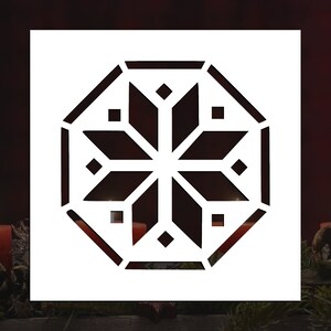 May include: A white stencil with a black geometric snowflake design. The snowflake is a traditional eight-pointed star with a repeating pattern of squares and diamonds.