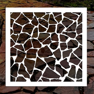 May include: A white square frame with a pattern of irregular brown shapes inside, resembling a stone pathway. The frame is set against a background of a real stone pathway.