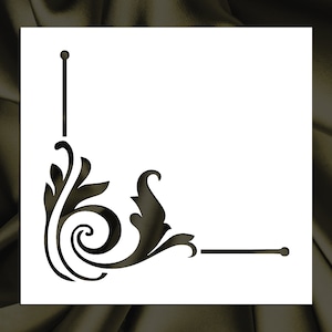 May include: A black and white stencil of a decorative corner design with a floral motif. The stencil is on a white background.