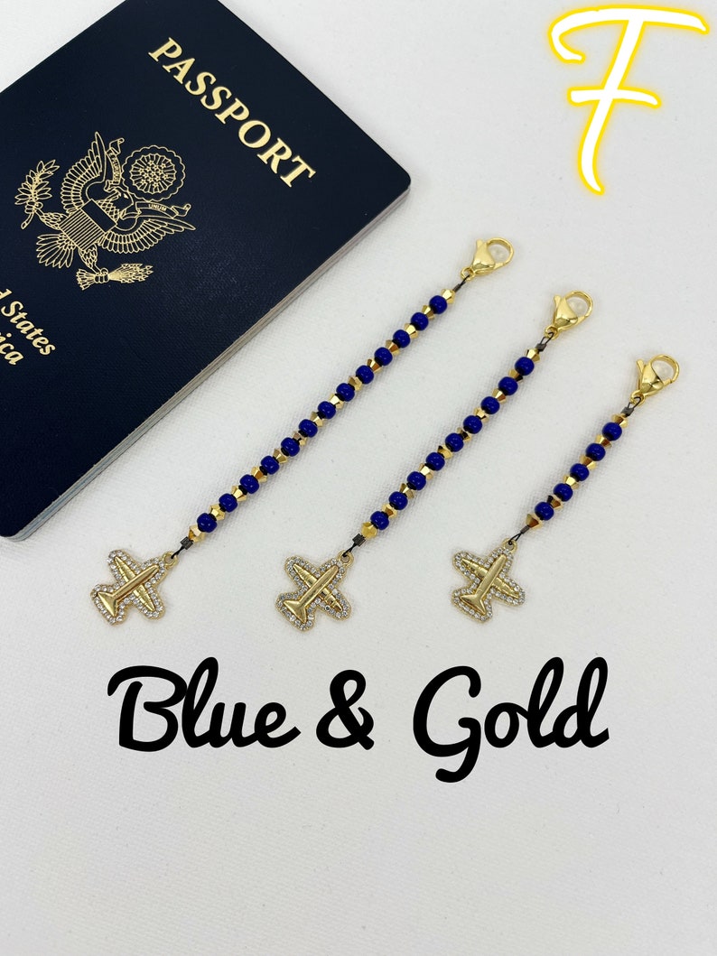 May include: Three gold airplane luggage tags with blue beads and gold clasps. The tags are on a white surface with a blue passport in the background. The text "Blue & Gold" is written below the tags.