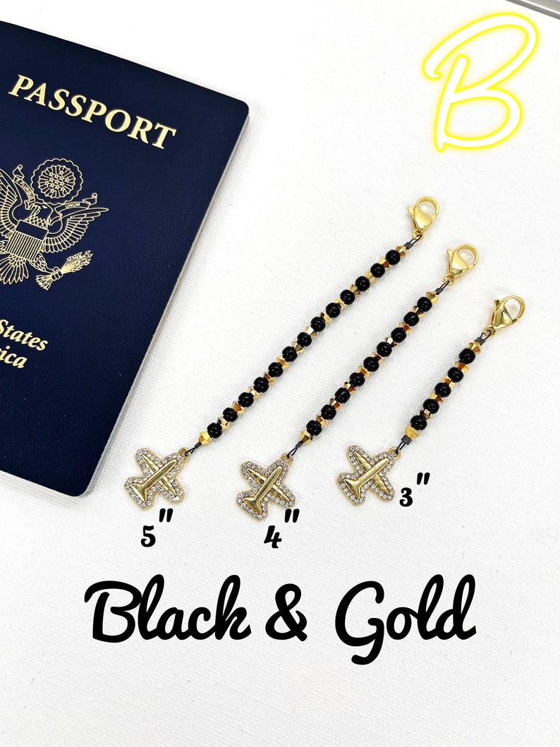 May include: Three black and gold beaded chains with airplane charms. The chains are 3 inches, 4 inches, and 5 inches long.  The charms are gold with rhinestones.  "Black & Gold" is written below the chains.