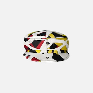 May include: A white, black, red, and yellow patterned cap with a short brim. The cap features a geometric design with a button on top and a small logo on the side. The cap is a stylish accessory.