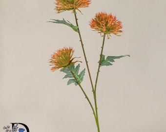 May include: A decorative artificial flower stem featuring three spherical orange blooms with spiky petals. The slender green stalk includes small thorns and several serrated green leaves attached at intervals along the main branch structure.