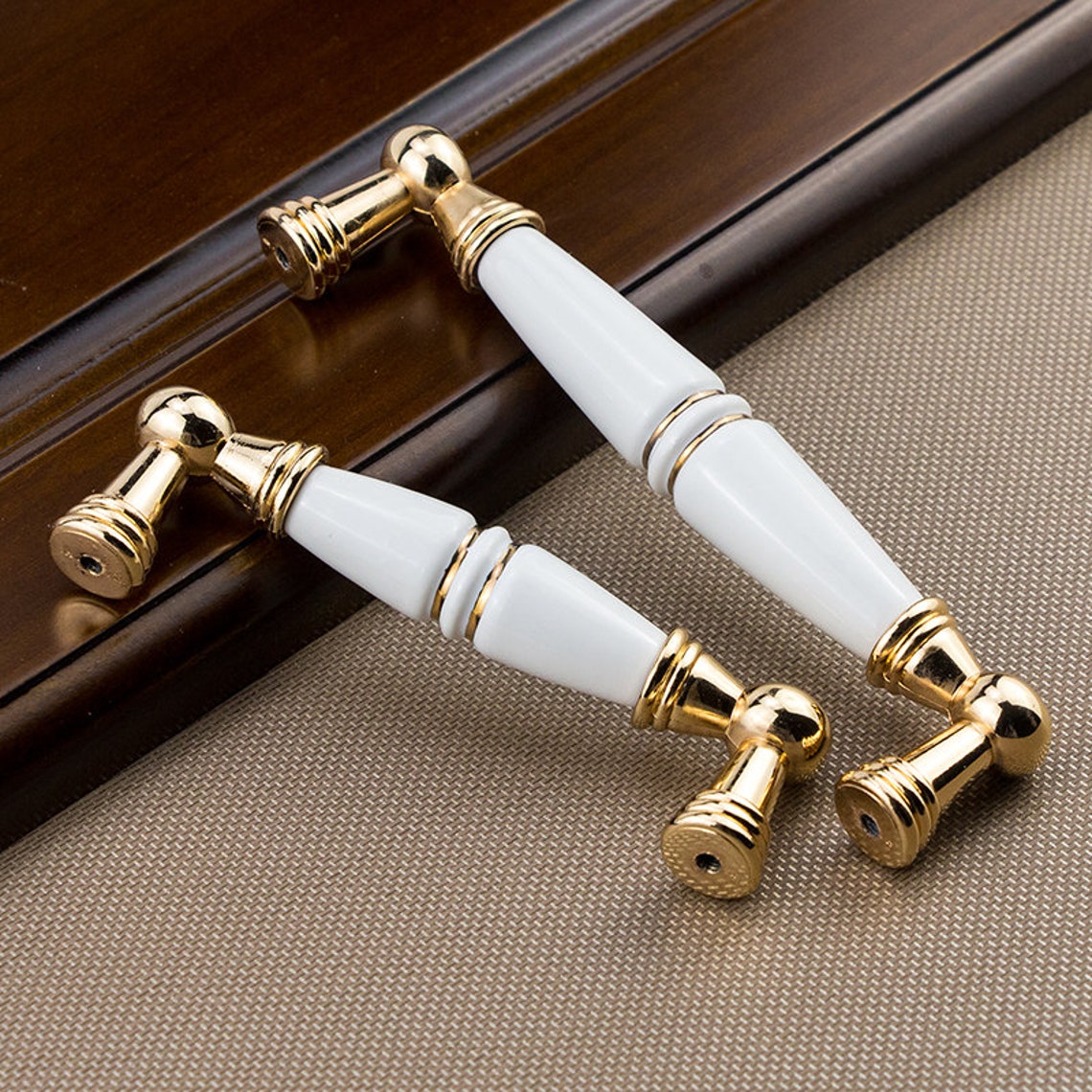 white and gold cabinet pulls
