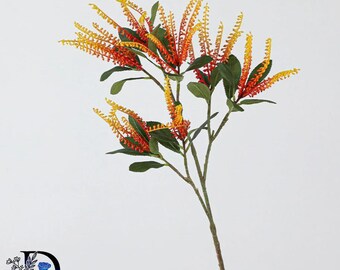 May include: A decorative artificial plant stem featuring multiple branches with green leaves and elongated, spiky flower clusters that transition in color from a deep red at the base to a bright yellow at the tips, set against a plain background.