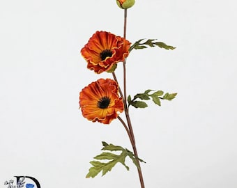 May include: A single artificial flower stem featuring two fully bloomed orange and red poppy flowers with dark centers, one small closed bud at the top, and several serrated green leaves attached to a thin, brown, upright stalk.