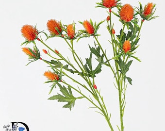 May include: An artificial plant stem featuring multiple spiky, vibrant orange thistle-like flower heads. The stem includes several green, serrated leaves and smaller buds branching out. The plant has a textured, realistic appearance with thin, green stalks.