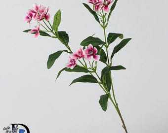 May include: A single artificial flower stem featuring multiple clusters of small, five-petaled blossoms in shades of white and deep magenta. The plant has slender green stems and pointed green leaves arranged along the length of the branch.