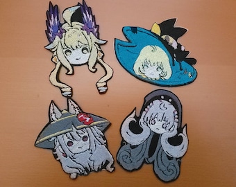 May include: Four embroidered patches featuring anime characters with different colored hair and clothing. The patches are on a brown surface.