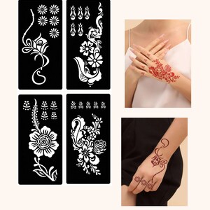 May include: Four black stencils with white floral designs for henna tattoos. The stencils are arranged in two rows of two. The stencils are shown on a white background. The image also shows two hands with henna tattoos.