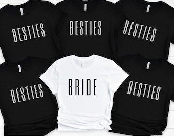 Peut inclure: Cinq t-shirts noirs avec du texte blanc qui dit "Besties" et un t-shirt blanc avec du texte noir qui dit "Bride".