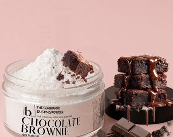 May include: A clear glass jar filled with white dusting powder and a piece of brownie. The jar has a label that reads "Chocolate Brownie" and "The Gourmand Dusting Powder". A stack of brownies with chocolate sauce and pieces of chocolate are also present.