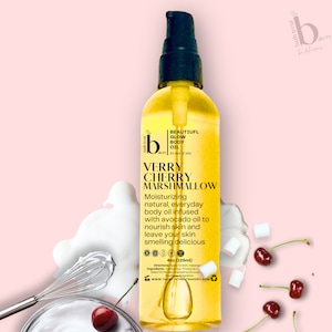 May include: A 125ml bottle of Verry Cherry Marshmallow body oil. The bottle is yellow and has a white label with black text. The text on the label reads "Beautiful Glow Body Oil for hair & skin" and "Verry Cherry Marshmallow". The bottle is sitting on a pink background with white marshmallows and red cherries.