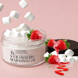 May include: A clear glass jar filled with pink dusting powder and topped with white marshmallows and fresh strawberries. The jar's label reads "Strawberry Marshmallow" and "The Gourmand Dusting Powder". The jar contains 4oz (118 ml) of product.