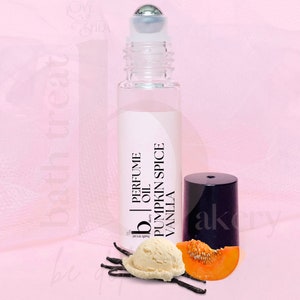 May include: A clear glass roll-on perfume bottle with a silver rollerball top. The label reads "Perfume Oil Pumpkin Spice Vanilla." It is accompanied by a scoop of vanilla ice cream, a slice of pumpkin, and vanilla pods. The background is pink.