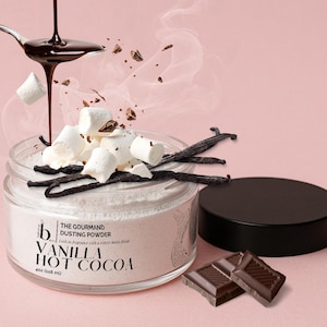 May include: A clear jar of Vanilla Hot Cocoa dusting powder with a black lid, labeled 4oz (118 ml). The jar is topped with white marshmallows and dark vanilla beans, while dark chocolate syrup pours from a spoon above the container.