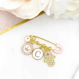 Personalised Pink Mini Evil Eye Baby Clothing Pin, Hamsa Hand, Crown, Letter