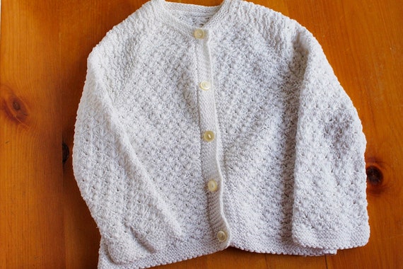 white knitted baby cardigan