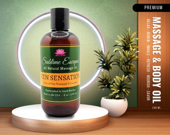 May include: A brown glass bottle of Sublime Escapes Zen Sensation all natural massage oil with hints of pure pineapple and coconut. The bottle is labeled with a pink lotus flower and the text "Handcrafted in Small Batches. Made in the USA - 8 oz. (240 ml)".