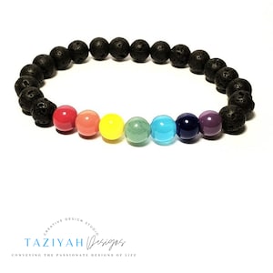 May include: A rainbow chakra bracelet with black lava rock beads. The bracelet features seven colored beads representing the seven chakras: red, orange, yellow, green, blue, indigo, and violet.