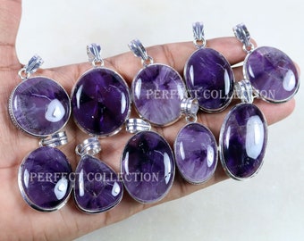 May include: A collection of amethyst pendants with silver-colored settings. The pendants have various shapes, including oval, round, and teardrop. The amethyst stones display shades of purple and white. The text "PERFECT COLLECTION" is visible on some pendants.