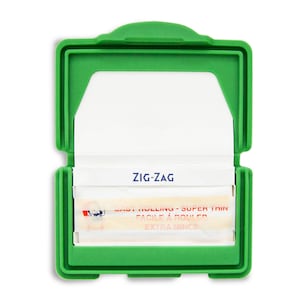 May include: A green plastic case with a white paper insert and a pack of Zig-Zag rolling papers. The papers are labeled "Easy Rolling - Super Thin" and "Extra Thincs".