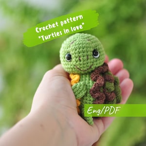 May include: Crochet pattern for a green turtle amigurumi with brown shell and yellow accents. The pattern is called "Turtles in love" and is available in English in PDF format.