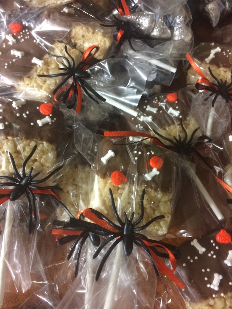 Halloween Cookies.   Rice Krispie Treats Pops dipped in chocolate and decorated for Halloween.  Individually bagged For Safety