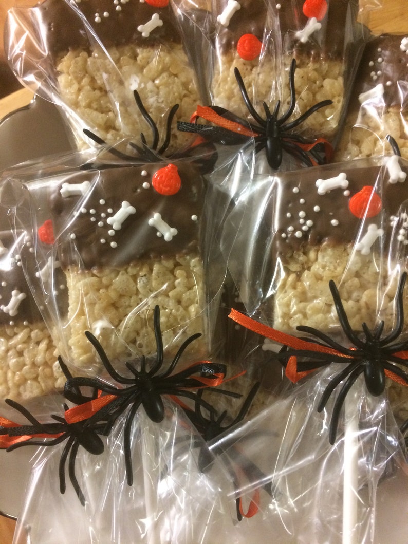 Halloween Cookies.   Rice Krispie Treats Pops dipped in chocolate and decorated for Halloween.  Individually bagged For Safety