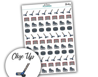 May include: A sheet of stickers featuring hockey-themed illustrations. The stickers include hockey sticks, pucks, skates, and nets. The stickers are white with black outlines and red, blue, and black accents. The sheet is labeled "Hockey" and "The Prairie Planner".