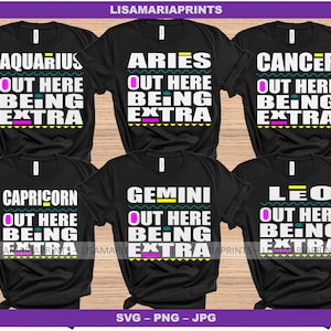 May include: Set of six black t-shirts with colorful text and graphics. Each shirt features a different zodiac sign with the text "Out Here Being Extra".