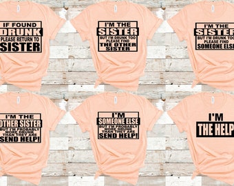 May include: Peach-colored t-shirts with black text. The shirts have various phrases, including "If Found Drunk Please Return to Sister," "I'm the Sister," and "I'm the Help." The shirts are likely for a group or family.