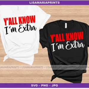 May include: Two t-shirts with the text "Y'ALL KNOW I'm Extra" in red and white lettering. The shirts are white and black and are laid out on a wooden surface.