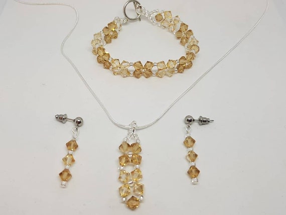Swarovski crystal bicone necklace bracelet and earrings to match in topaz and light topaz