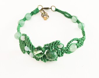 Macrame bracelet with asymmetrical design, green cord, amazonite and jade beads, and Swarovski crystal globe bead