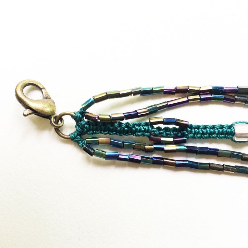 Macrame bracelet with brass cat charm and glass rainbow tube and seed beads and square light pink glass beads