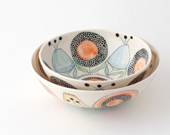 A pair of handmade ceramic serving bowls with flowers, light and fun, outdoor table setting, translucent one of a kind porcelain bowls