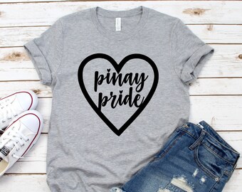 May include: A gray t-shirt with a black heart design and the text "Pinay pride" inside the heart.