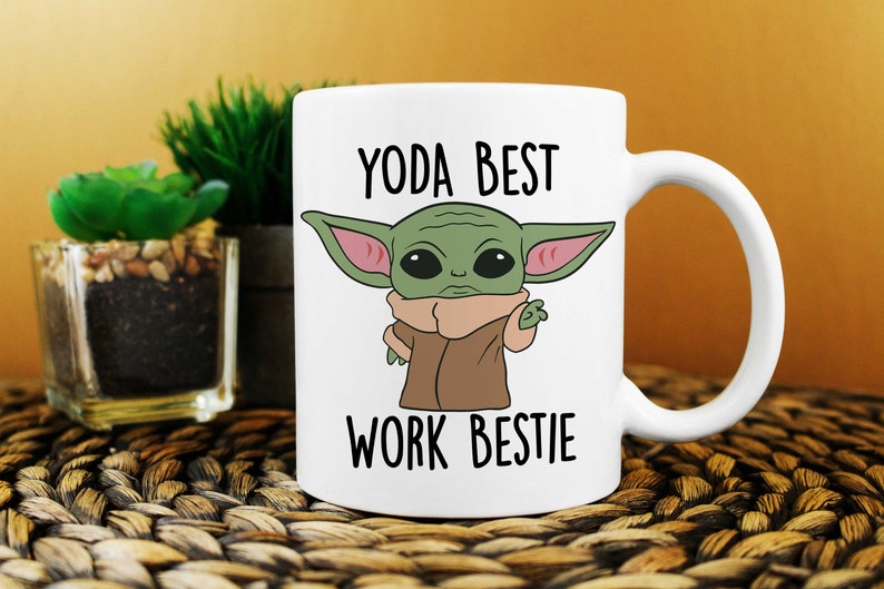May include: White ceramic mug with a green cartoon character with large ears and the text "YODA BEST WORK BESTIE".