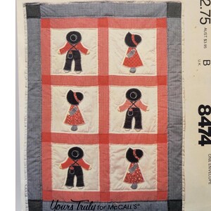 May include: A McCall's pattern envelope featuring a quilt design. The quilt has a grid pattern with six squares, each showcasing a doll-like figure in red and black. The envelope includes text: "McCall's", "Yours Truly for McCall's", and price information.