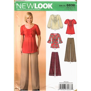 May include: A New Look sewing pattern featuring a red top with ruffle detail and wide-leg tan pants. The pattern includes multiple top and pants designs. The text "NEW LOOK" is at the top, with size information and a website address.