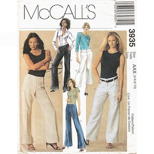 May include: McCall's sewing pattern 3935, size AAX (4-6-8-10), features illustrations of various pants styles including wide-leg trousers, cuffed pants, and fitted slacks paired with sleeveless tops, long-sleeve shirts, and t-shirts for diverse outfits.