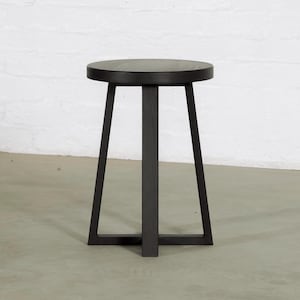 May include: A black side table with a round top and three legs. The table is made of wood and has a minimalist design. The table is approximately 51 cm tall.