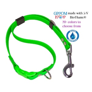 May include: Green BioThane dog lead with a silver clip and a black buckle. The lead is made with 5/8 inch BioThane and is water resistant. The text "Groom Loop" is printed on the lead. The text "20+ colours to choose from" is printed below the lead.