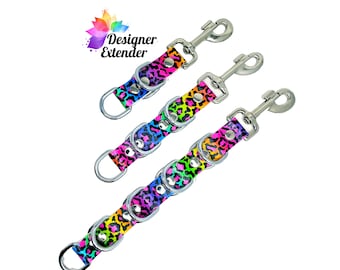 May include: Three colorful leopard print dog leash extenders with silver swivel clips and D-rings. The extenders are in rainbow colors with black spots. The extenders are labeled "Designer Extender".