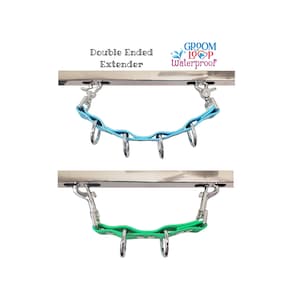May include: Double ended extender for a dog lead, shown in two colours: light blue and green. The extender is made of a rubber material and has metal hooks on each end. The text "Groom Loop Waterproof" is printed on a silver bar.