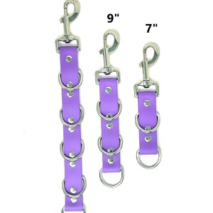 May include: Three purple leather straps with silver metal rings and clips. The straps are 7 inches, 9 inches, and 13 inches long.