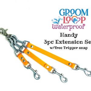 May include: Orange waterproof dog leash extension set with three clips and a trigger snap. The set is labeled "Groom Loop Waterproof Handy 3pc Extension Set w/free Trigger snap".