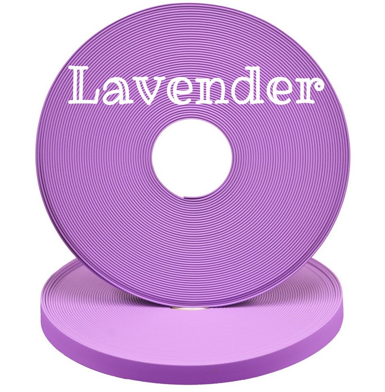 May include: A roll of lavender colored webbing, the roll is stacked on top of another roll of the same webbing.