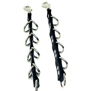 May include: Two black leather straps with silver metal rings and clips. The straps are about 12 inches long and have five rings each. The rings are about 1 inch in diameter. The straps are labeled "Large".